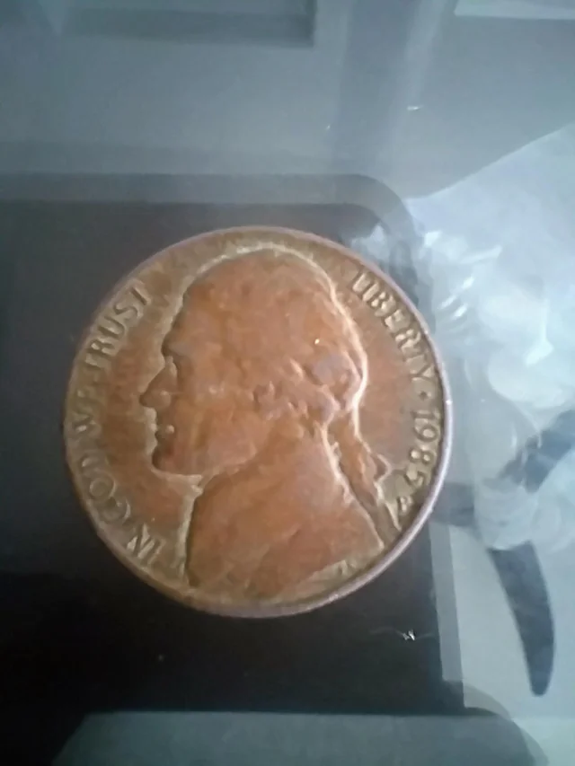 1985-P nickel struck on wrong Lincoln cent planchet showing smaller bronze disc with partial design