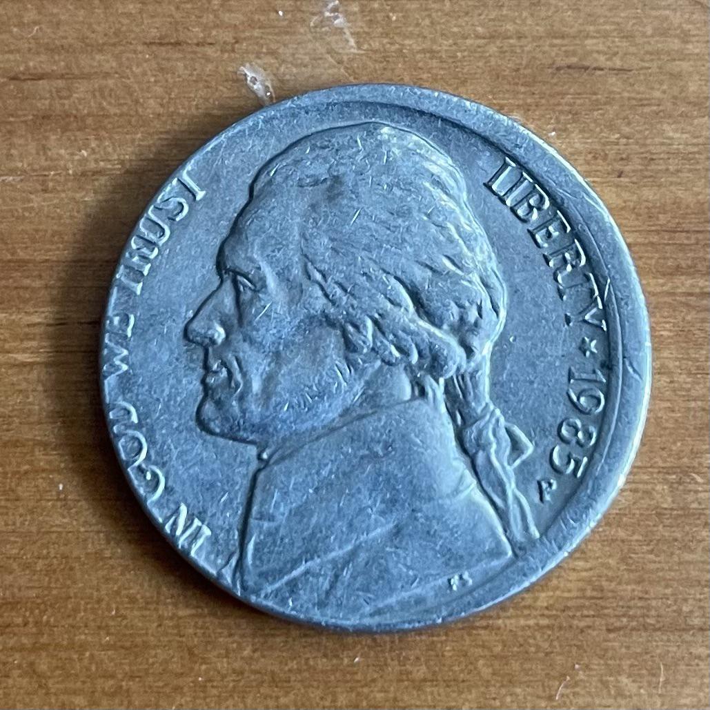 1985 Jefferson nickel off-center strike showing design shifted with blank crescent area and full date visible